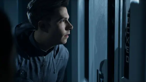 A dark, atmospheric hallway in Directive 8020 where the player must navigate past locked doors and alien threats.