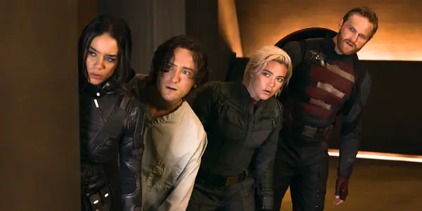 The ensemble cast of Thunderbolts* standing together in a gritty, cinematic shot from the film.