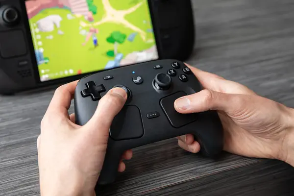 The Steam Controller shown in a studio environment with its signature dual trackpads and ergonomic design.